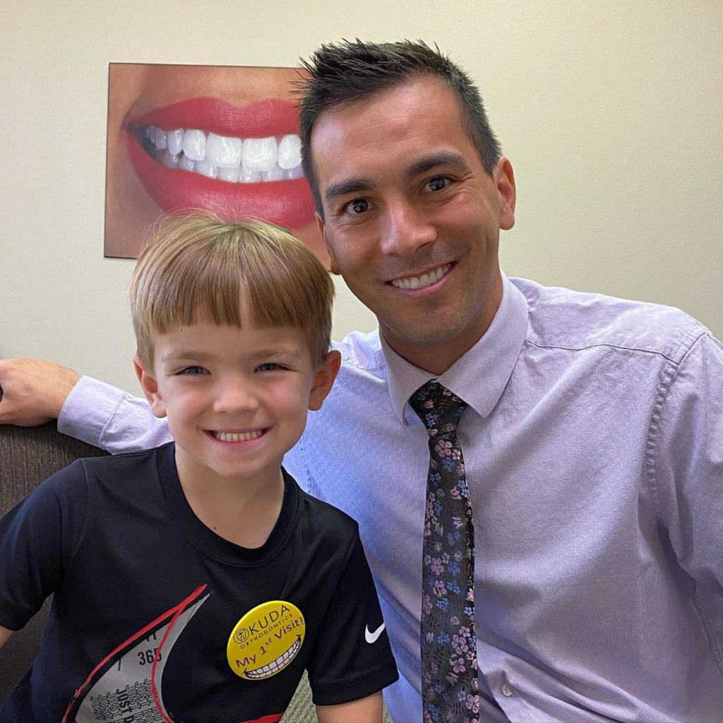 dr Okuda with a young patient smiling