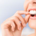 woman putting in Invisalign